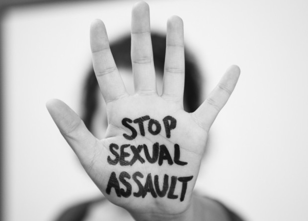 Hand with Stop Sexual Assault written on palm